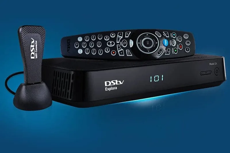 Technician connecting an Explora decoder during a DSTV installation